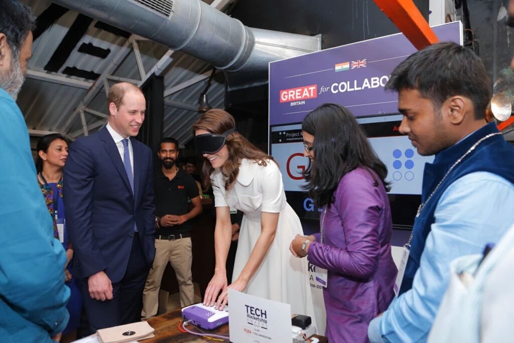 Image of the Duke and Duchess of Cambrodge learning to type on Annie